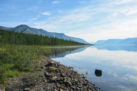 A mountain lake on the Putorana plateau. Water landscape in the region of active tourism in Russia.の写真素材