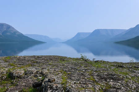 A mountain lake on the Putorana plateau. Water landscape in the region of active tourism in Russia.の写真素材