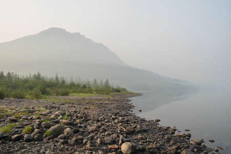 Putorana Plateau. Fog on a mountain lake. Water landscape in a foggy haze.の写真素材