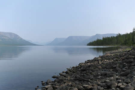 Putorana Plateau, a misty haze over the lake. Summer lake landscape in Eastern Siberia.の写真素材