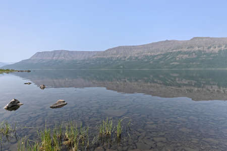 Putorana Plateau, a misty haze over the lake. Summer lake landscape in Eastern Siberia.の写真素材