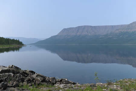 Putorana Plateau, a misty haze over the lake. Summer lake landscape in Eastern Siberia.の写真素材