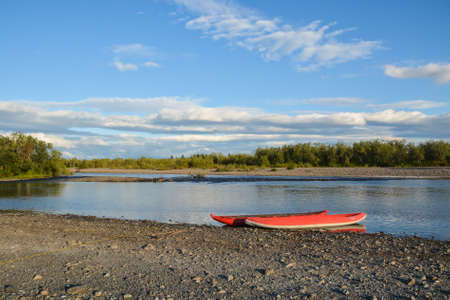 Boat trip in the Northern Urals. Summer river landscape with inflatable kayak.の写真素材