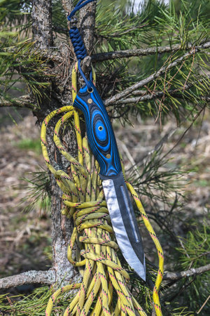 bushcraft equipment. Knife and rope lit by the sun.