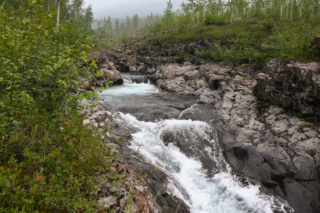Rapids on a mountain stream. Cloudy landscape, Grayling creek on the Putorana plateau.の写真素材