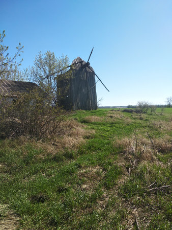 Old wooden windmill in the field. Spring landscape. Ukraine.の写真素材
