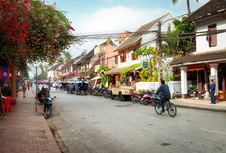LUANG PRABANG, LAOS - 8 DEC, 2013  Unidentified citizens of Luang Prabang on their daily routine at central part of touristic district of the city  Outdoor street view  Popular travel destinationのeditorial素材