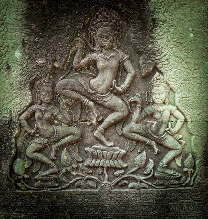 Angkor Wat Cambodia. Bayon temple in Angkor Thom historical place. Human face and figures murals and...