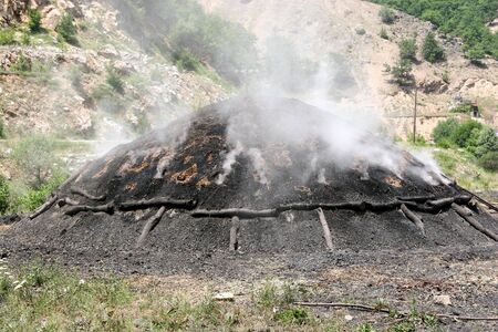 Production of charcoal for braziers and a barbecue. The 2nd stage - receiving coalの写真素材