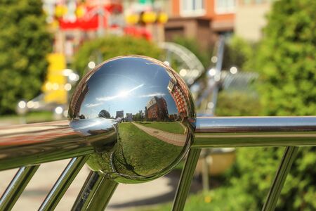 Reflections of the city in a metal ball. Modern Architectureの写真素材