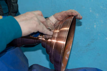 Coppersmith is working in his shop in Suleymaniye, Istanbul. Copper working in Suleymaniye is a...