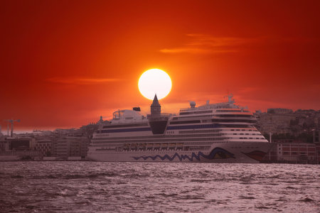 Fiery sunset over Bosphorus with famous Galata Tower also known as Galata Tower, symbol of Istanbul, Turkey. Scenic travel background and cruise shipのeditorial素材