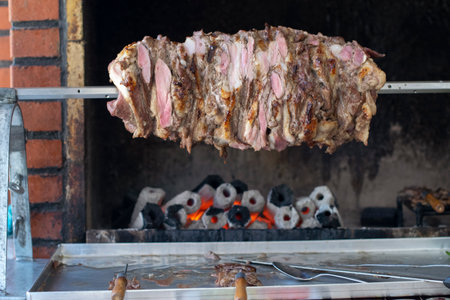 Chef prepares a traditional Turkish cag kebab at an open restaurant in Istanbul.Cag kebab is looks like doner kebab,but it is put front the fire horizontal.の写真素材