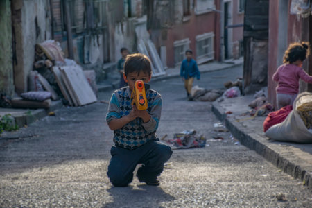 Photo taken on 23th May 2015, Istanbul, Turkey: Syrian child playing with toy gun on the street in Istanbulのeditorial素材