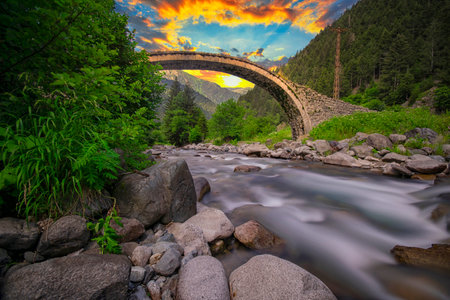 Ancient stone bridge over a mountain river in Natural Area.の写真素材