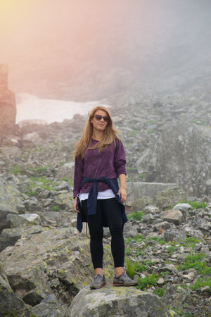 A young girl watches the crater lake and mountains in the high altitude Kackar plateaus..