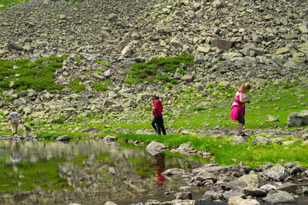 A group of photographers takes a photo of the crater lake mountains in the high altitude Kackar plateaus..の写真素材