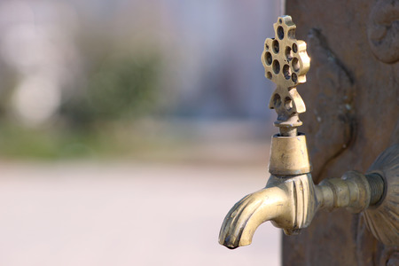 Drop of water dripping closeup from Turkish ottoman style antique water tap. Antique Ottoman faucet.の写真素材