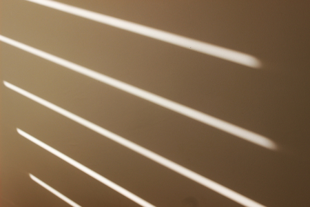 Sunlight from the window of the room on the wall close-upの写真素材