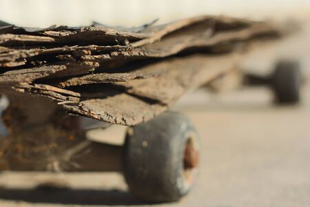 Old cracked skateboard on the sandの写真素材