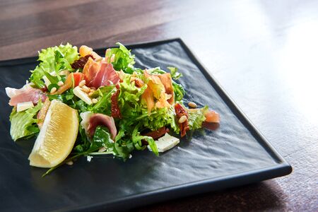 Eating healthy. Closeup of a prosciutto or jamon salad with arugula lemon dorblu cheese and pine nuts copyspaceの写真素材
