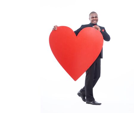 Full lenght portrait of man holding big heart.の写真素材