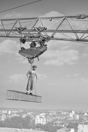 Professional builder dressed in vintage outfit posing on a crossの写真素材