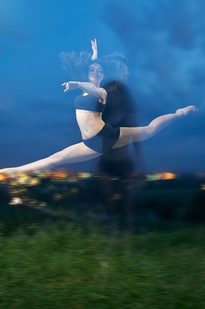 pretty, young, smiling dancer performs splits in the airの写真素材