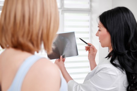 Beautiful young woman visiting doctorの写真素材