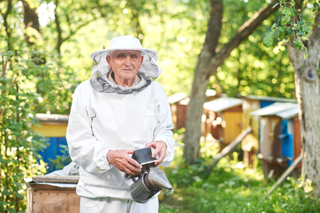 Senior beekeeper working at his apiaryの写真素材