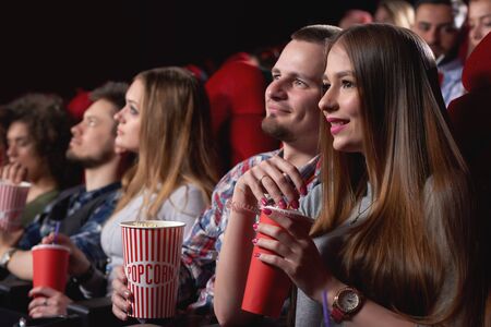 Group of people enjoying movie at the cinemaの写真素材