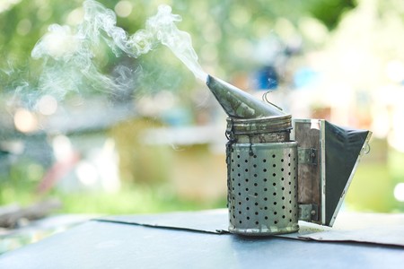 Old fashioned metal bee smoker at the apiaryの写真素材