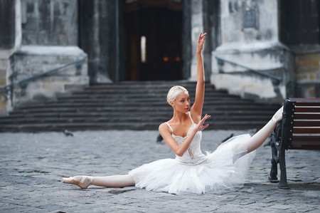 Attractive ballerina sitting on the bench in the cityの写真素材