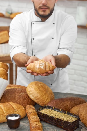 Professional baker working at his kitchenの写真素材
