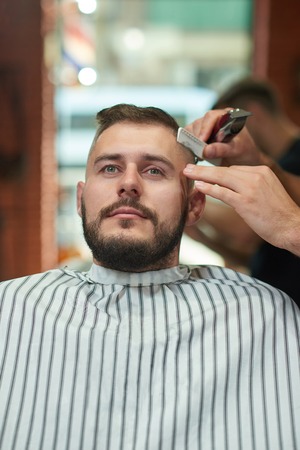 Young man at the barbershopの写真素材