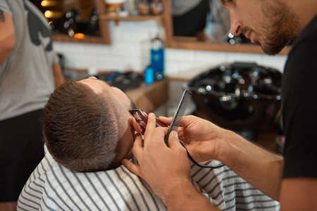 Young man at the barbershopの写真素材