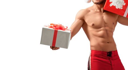 Muscular Santa Claus holding presentsの写真素材