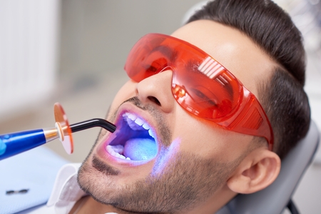 Young man visiting dentistの写真素材