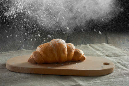 Freshly baked croissants on wooden tableの写真素材