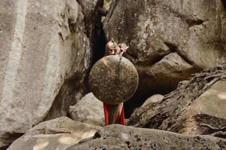 Gladiator covering with shield while attackingの写真素材