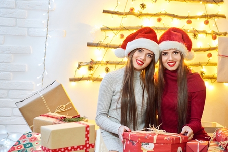 Beautiful twins in Christmas outfitsの写真素材