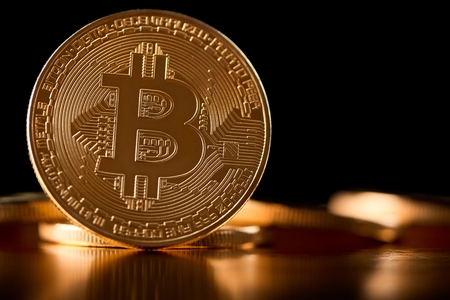 Golden bitcoin as main digital currency worldwide presented on blurred background with other cryptocurrencies.の写真素材