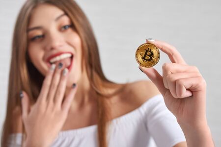 Bitcoin hold by excited pretty female modelの写真素材