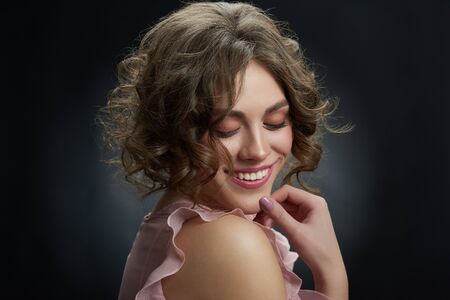 Portrait of curly girl, who is smiling.