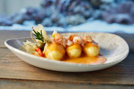 Delicious, tasty dish with grilled shrimps served on plate in modern restaurant.の写真素材