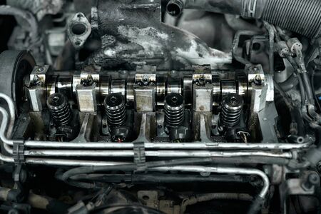 Dismantled car engine under bonnet with dirty nozzles, pistons,crankshaft and iron tubes are waiting...
