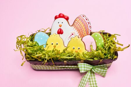 From above view of glazed cookies in shape of lovely yellow chicks, chicken and colorful eggs lying...