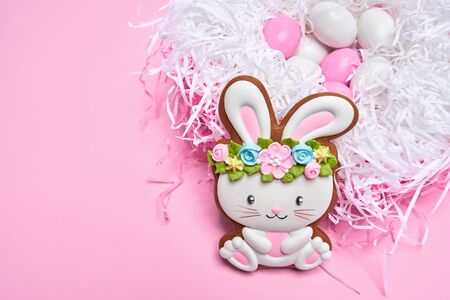 Close up of lovely pastry isolated on black background. Selective focus of easter bunny in flower...