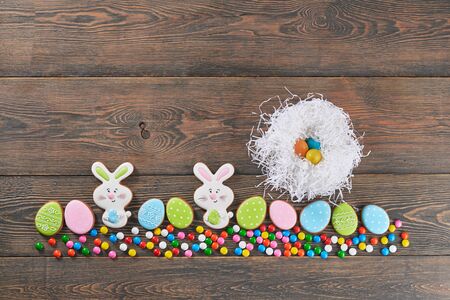 From above view of peanut chocolate balls in crispy sugar shell isolated on wooden background....