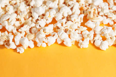 Close up of neatly folded popcorn on orange background. Concept of crispy corn.の写真素材